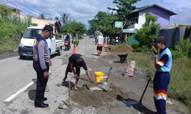 Warga dan Polsek Loakulu Tambal Jalan Berlubang di Desa Rempanga